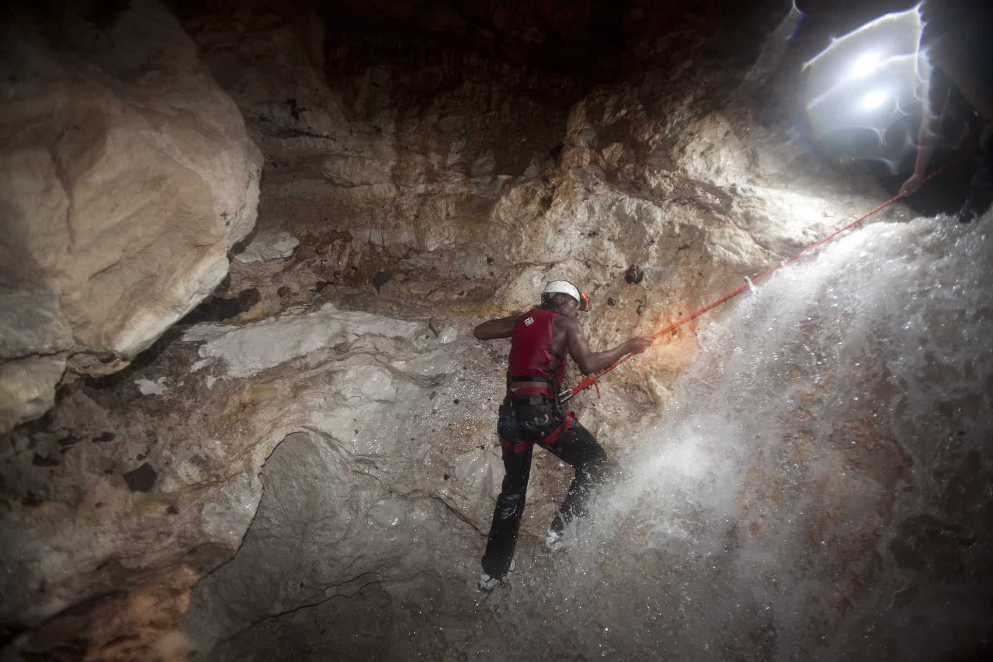 belize waterfall rappelling cave expedition horizontal male web